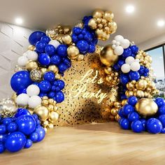 blue and gold balloon arch in an office