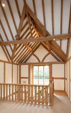 an empty room with wooden beams and white walls