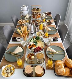 a dining table set with food and drinks