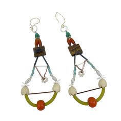 These Bohemian-style dangle earrings are a unique blend of vibrant colors and intricate design. Crafted with an assortment of beads and geometric charms, they add a touch of artistic flair to any ensemble. The earrings are lightweight, making them comfortable for all-day wear, and their eclectic mix of materials ensures they will stand out in any jewelry collection. * Handmade design * Bohemian style * Various beads and charms * Lightweight and comfortable * Approx. 4 inches long * Hook closure * Geometric patterns Length of each earring = approx. 4 inches Features: * Boho Size: 3" Condition: Pre-Owned Good Colorful Beads Dangle Chandelier Earrings, Colorful Beaded Dangle Chandelier Earrings, Dangle Chandelier Earrings With Colorful Beads, Unique Chandelier Drop Earrings With Dangling Beads, Bohemian Beaded Dangling Earrings, Bohemian Beaded Dangle Earrings, Handmade Multicolor Bohemian Danglers, Bohemian Chandelier Earrings With Colorful Beads, Multicolor Teardrop Hoop Earrings Bohemian Style