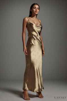 a woman in a gold dress posing for the camera