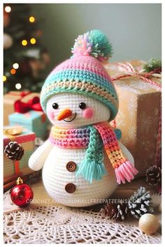 a knitted snowman sitting next to presents