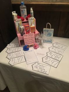 a table topped with lots of items on top of a white cloth covered tablecloth