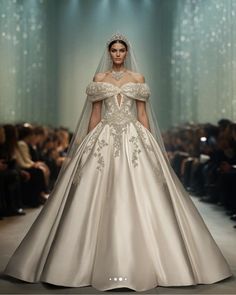 a woman in a wedding dress on the runway