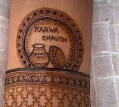 a woman's leg with a tattoo on it that says karwa chauth