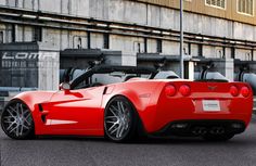 a red sports car parked in front of a building