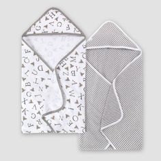 two baby swaddles are shown next to each other, one with an envelope and the other with letters on it