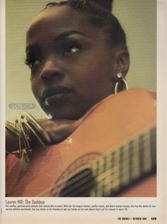 a woman holding an acoustic guitar in front of her face