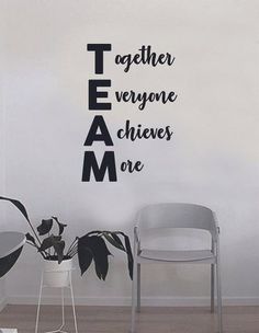 there is a wall sticker that says together everyone achieves one in black and white