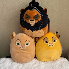 three stuffed animals sitting next to each other