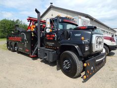 a tow truck parked in front of a building