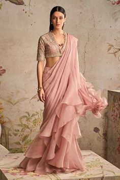 Dusky pink pre-draped saree with ruffle border. Paired with sequin, bead, cutdana half sleeve net embroidered blouse.
Components: 2
Pattern: Embroidery
Type Of Work: Sequin, bead, cutdana
Neckline: Plunge V neck
Sleeve Type: Half sleeves
Fabric: Saree: Chiffon, Organza, Blouse: Net
Color: Pink
Other Details: 
Back cut-out blouse
Occasion: Reception - Aza Fashions Drape Sari, Ridhi Mehra, Saree Wearing Styles, Net Blouses, Organza Blouse, Ruffle Saree, Embroidered Crop Tops, Drape Saree, Ruffle Fabric