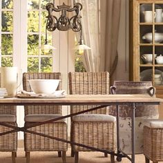 the dining room table is set with wicker chairs