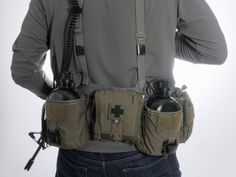 a man holding two flasks in his back pocket while talking on the phone