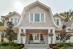 a large house with white trim and windows