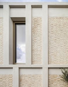 a window in the side of a white brick building