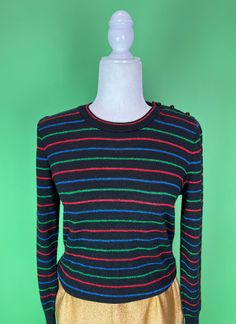 Vintage 70s/80s Black metallic striped sweater It's holiday sweater time and this one can work for the rest of winter too! Simple black acrylic knit with red, green, and blue metallic stripes and shoulder button closure. * label: It's Pure Gould * size marked: none, fits like a modern S/M (please see measurements) * materials: feels like acrylic with metallic thread * approximate measurements (taken lying flat): plus a lot of stretch to this knit bust - 18 in. length - 21.5 in.  shoulders - 14 i Retro Striped Winter Sweater, Retro Striped Sweater For Winter, Fitted Retro Striped Sweater, Christmas Party Sweater, Pull Vintage, Sparkly Sweater, Party Sweaters, Womens Sweaters, Sweater Christmas