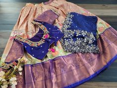 This Traditional Half Saree Set is a must-have for any woman looking to add a touch of elegance and tradition to her wardrobe. Made from premium quality Kanchi material, this saree set is not only beautiful but also durable and comfortable to wear. The set includes a blouse that is stitched and comes in a size 34, with inner margins that can be expanded up to size 40. For those who need a size 32, alterations can be done upon request. The lehenga is also expandable and has inner margins to incre Elegant Multicolor Sets With Traditional Drape, Traditional Designer Sets With Unstitched Blouse, Traditional Designer Wear Sets With Unstitched Blouse, Designer Wear Sets With Unstitched Blouse, Designer Banarasi Silk Sets With Unstitched Blouse, Multicolor Banarasi Silk Designer Sets, Designer Multicolor Banarasi Silk Sets, Traditional Silk Saree With Patterns, Multicolor Banarasi Silk Sets With Unstitched Blouse