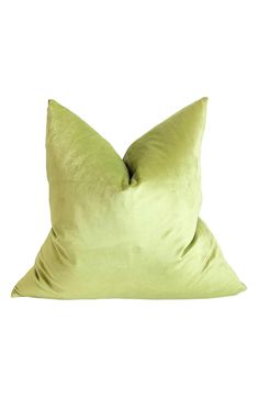 a lime green pillow on a white background