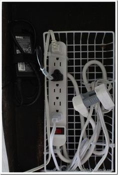 an electrical outlet is plugged in to a wall charger with multiple wires and cords