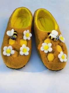 Introducing our cozy and incredibly charming handmade felted slippers, crafted with love and skill from natural merino wool. Each pair of slippers features a delightful design of honeycomb patterns in a warm ochre color, adorned with lifelike felted wool bees resting on their hives. With our handmade slippers, you'll experience a blend of comfort and style with every step. The soft and luxurious material envelops your feet, providing a sensation of unmatched coziness. These slippers are the perfect companions for relaxing evenings at home or unwinding after a long day. The slippers are thoughtfully designed with a leather sole, ensuring durability and protection against wear. The lightweight sole adds a natural ease to your movements, although it's essential to be mindful of smooth surface Ochre Color, Handmade Slippers, Indoor Shoes, Felted Slippers, Warm Slippers, Honeycomb Pattern, Wool Handmade, Felted Wool, Sheep Wool