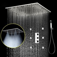 a shower head with rain coming from it's side and an overhead faucet