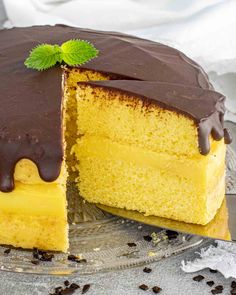 a yellow cake with chocolate frosting and a slice cut out