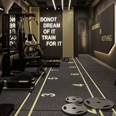 there is a gym with exercise equipment on the floor and in front of an illuminated sign that says don't dream of it train for it