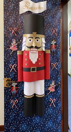 a large nutcracker standing in front of a blue wall with stars on it