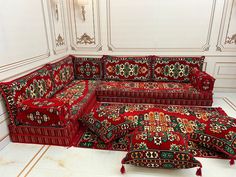 a couch and ottoman in a room with white walls