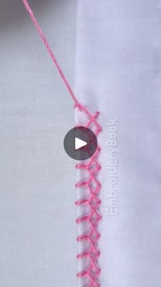 the video is showing how to make a crochet stitch on a white shirt