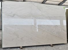 a large marble slab sitting on top of a metal stand