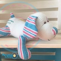 a stuffed dog laying on top of a wooden bench