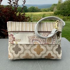 "Medium Size Wristlet. Neutral Color Wristlet with a Pearl Gray Leather Strap. Super Quality Industrial Upholstery Fabric. Large front zip pocket. Top zip opens to roomy interior. There's one inside pocket big enough for your credit cards,plus a large pocket that will fit a phone(or you could put it in the outside pocket ...)AND there's a clip off key ring 8.5\" wide 6\"deep 1 1/4\"bottom Use as your only bag, or use like a wallet and carry in a bigger bag. Great for an Evening bag , or when you Clutch Bags With Wrist Strap As Gifts, Everyday Handheld Bags With Wrist Strap, Everyday Handheld Bag With Wrist Strap, Travel Wristlet With Removable Pouch, Handheld Bags With Wrist Strap For Gifts, Coin Purse Clutch With Wrist Strap, Daily Use Clutch Wristlet With Removable Pouch, Wristlet Pouch For Mobile Phone, Mobile Phone Bag Wristlet Pouch