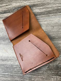 "This is one of our most popular wallets and the one I've personally used for years.  It's a simple bifold with slots for cards and licenses.  It's made from full-grain 3-4 oz Herman Oak veg-tanned cowhide - the finest leather there is!  Its appeal is its ability to hold a lot of stuff without the bulk of transitional bi-folds.  Mine is currently holding 2 licenses, my insurance card, 5 credit cards, a couple receipts, and 23 folded bills (see the last 2 photos).  The low profile is due to its s Brown Leather Trifold Envelope Wallet, Brown Leather Trifold Wallet With Waxed Finish, Minimalist Leather Trifold Wallet, Minimalist Leather Trifold Wallet With Card Slots, Brown Leather-lined Trifold Wallet, Unique Wallets, Minimalist Wallet, Clip Wallet, Money Clip Wallet