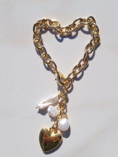 "This Sylvie Gabrielli My Only Heart Bracelet is a beautiful handmade accessory composed of freshwater pearls and a vintage heart charm. The combination of these quality materials makes this a timeless piece that is sure to be treasured for years to come. My Only Heart Bracelet features a plated gold link chain, drops of Freshwater Pearls with a Vintage Heart Charm.Features:- Authentic Vintage Gold Heart Bead- Freshwater Pearls- Lobster ClaspDimensions:-Length: 7.5\"-Extension: 2\"- Heart Diamet Heart-shaped Pearl Bracelet For Wedding, Pearl Heart Bracelet Gift, Heart-shaped Pearl Charm Bracelet For Wedding, Heart-shaped Pearl Bracelet With Charm For Wedding, Elegant Pearl Heart Bracelet With Charm, Pearl Heart Bracelet For Wedding, Wedding Pearl Heart Bracelet, Wedding Heart-shaped Pearl Bracelet, Pearl Heart Bracelet For Valentine's Day Gift