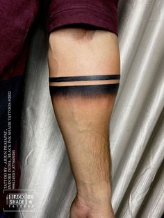 a man with a black and white tattoo on his leg