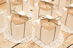 small gift boxes tied with twine and thank you tags