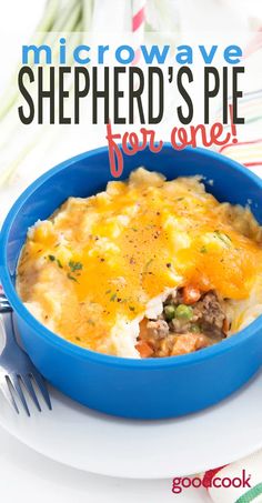 a blue bowl filled with shepherd's pie on top of a white plate