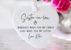 a ceramic heart shaped ornament that says sister - in - law marriage made you my family love made you my sister