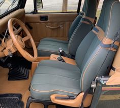 the interior of a car with blue and tan leather seats