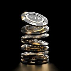 a stack of poker chips sitting on top of each other in front of a black background