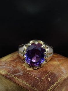 This beautiful 20th Century ring has great style featuring a large oval cut synthetic sapphire with slight colour change this stone features blue and purple but floureses vibrant orange under uv light. The gemstone is set in warm 9ct gold this gold has a slight Rosey tone common with items of this age.  UK size - Q US size - 8 Weight approx - 4.83 grams  Face length approx - 14.4 mm Message me any questions Vintage Oval Gemstones For Gift, Formal Amethyst Oval Cabochon Ring, Classic Amethyst Birthstone Ring, Classic Oval Purple Gemstones, Classic Oval Purple Amethyst Ring, Classic Purple Oval Gemstones, Classic Ring With Large Stone, Classic Oval Gemstone With Center Stone, Classic Large Stone Amethyst Ring For Formal Events