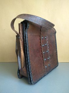 Vintage Bag Of Genuine Calfskin - Retro leather bag - Old leather bag from 60' - brown leather bag - Genuine Leather Bag - Shoulder bag The old bag has traces of use. Dimensions : The length of the handle / strap / - 58 centimeters 22 cm x 23 cm x 7 cm For other vintage bag check here : https://www.etsy.com/shop/TheVINTAGEShopBG?ref=l2-shop-info-name&section_id=22456024 FAST SHIPPING ! Possible express delivery with DHL but please first ask me for price . All pictures are real . You buy exac Brown Leather-handled Crossbody Box Bag, Brown Leather Handle Shoulder Box Bag, Brown Leather Saddle Shoulder Bag, Brown Leather Hobo Shoulder Bag, Brown Leather Shoulder Bag With Leather Lining, Brown Leather Saddle Bag With Leather Lining, Rectangular Leather Shoulder Bag With Leather Lining, Brown Leather Shoulder Bag With Textured Leather, Brown Leather-lined Satchel Bag