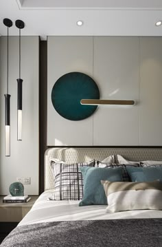 a bed with pillows, blankets and lamps in a modern style bedroom setting on the wall