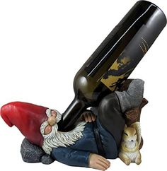 a figurine with a wine bottle on it's back and a dog sitting next to it