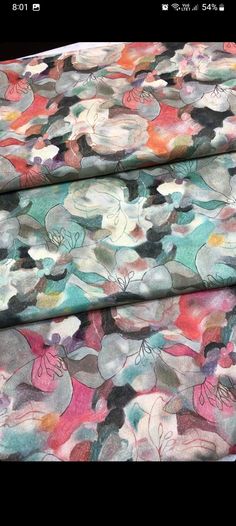 two fabric pieces with flowers on them, one in pink and the other in blue