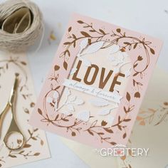 a card with scissors and some paper on it next to twine of twine