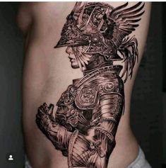 a man's back with tattoos on his body and an image of a woman in armor