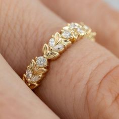 a woman's hand with a yellow gold ring on it